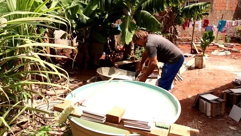 A Volunteer Worker Cleaning up after Working on a Neighbor’s House. Stock Footage 118933287