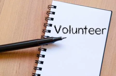 Volunteer write on notebook Stock Photos