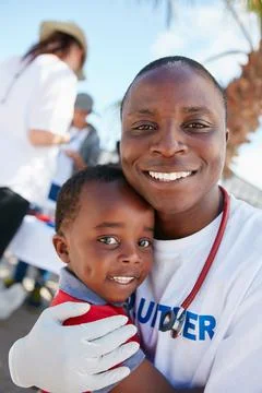 Volunteering for the love of kids. Portrait of a caring volunteer doctor givi Stock Photos