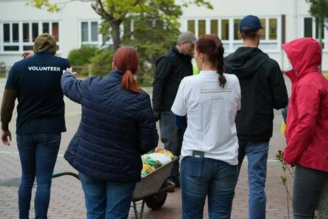 Volunteers chatting while getting ready for work Stock Photos