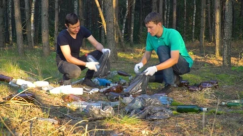 Volunteers clean up garbage in forest Stock Footage 118264559
