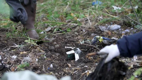 Volunteers collect garbage in the forest, put garbage in black large bags. Stock Footage 195297650