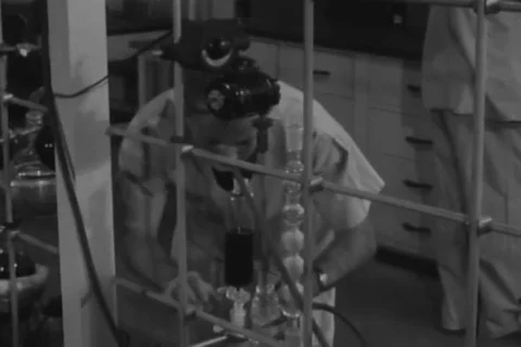 Volunteers enter a room for experiment on effect of biological component - 1950 Video stock 102178760