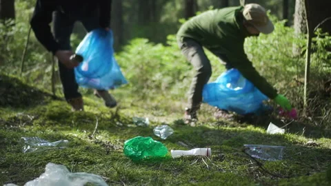 Volunteers in forest picking trash. Spbd two male people cleaning problem Stock-Footage 131092653
