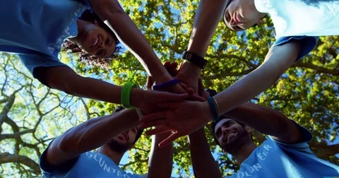 Volunteers forming a hand stack 4k | Stock Video | Pond5