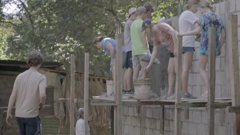 Volunteers helping with construction on wall in small village in Guatemala Stock Footage 235254141
