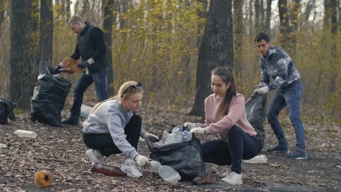 Volunteers picking up garbage plastic Stock Footage 128534422