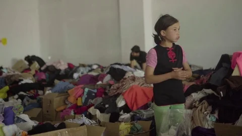 Volunteers sorting boxes full of donated clothes for earthquake victims Stock Footage 77453234