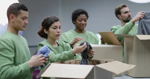 Volunteers sorting clothes donations Stock Footage 86827406