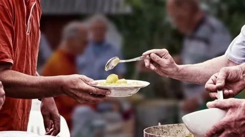 Volunteers in soup kitchen serving food for the poor. Parallax creation. Stock Footage