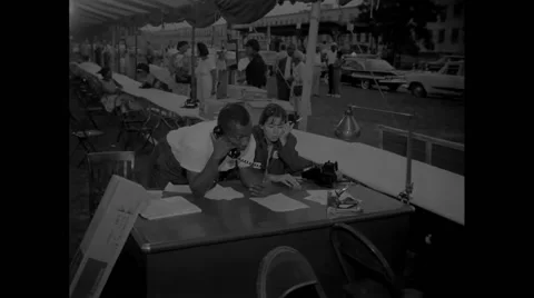 Volunteers talking on telephone during Civil Rights March Stock Footage