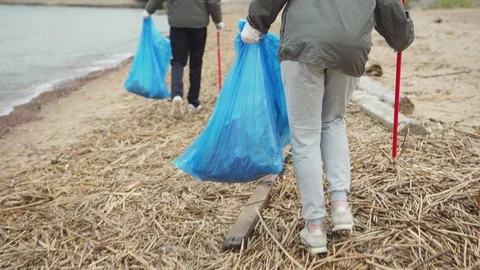 Volunteers using trash pickers to collect rubbish Video stock 111310681
