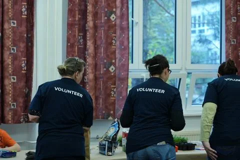 Volunteers working at a table Stock Photos