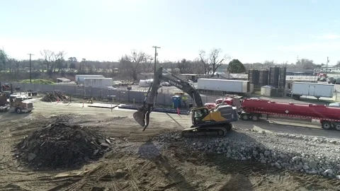 Volvo Loader leveling ground with K-Rail Stock Footage 168323707