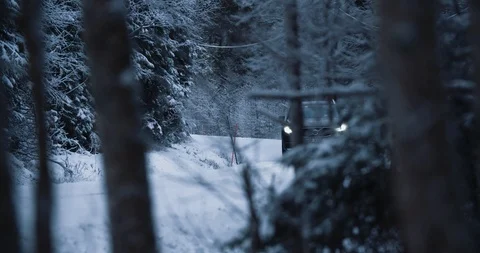 Volvo XC90 driving on snow roads in a forest somewhere in Norway. Filming Stock Footage
