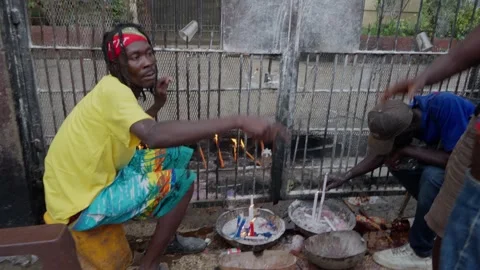 Voodoo candle ceremony at cemetery gate in Haiti Stock Footage 318965219