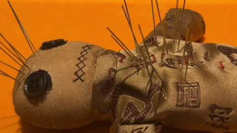 Voodoo doll made of fabric with needles stuck in it 스톡 동영상 341576436