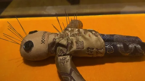 Voodoo doll made of fabric with needles stuck in it 스톡 동영상 341579067