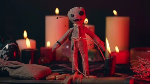Voodoo doll in ritual scene close up, magic table with candles, witchcraft and Stock Footage 205264876