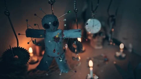 The voodoo doll swinging on the hook over the ritual table Stock Footage 78190812