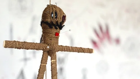 Voodoo doll turns round slowly on white background with creepy symbols Stock Footage 114361653