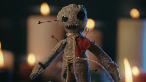 Voodoo Magic concept. Voodoo doll studded with needles with pierced rag heart Stock Footage 161918544