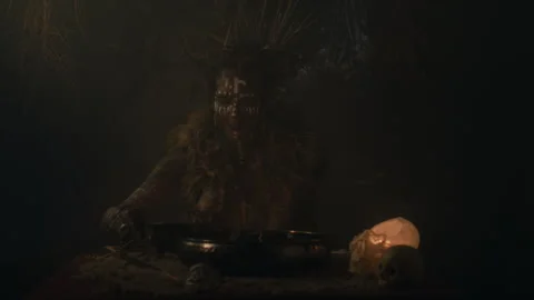 Voodoo Witch Doctor using a mixture in a dark room Stock-Footage 259867862