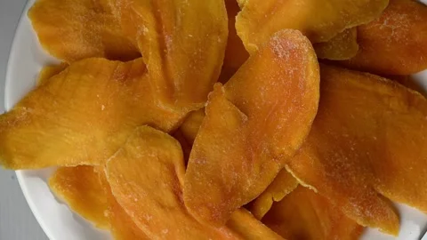 Vortex of Dried Mango Slices. Abstract Tropical Fruit Spin, Seamless 4K Loop Stock Footage 325966915