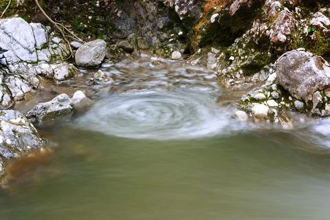 Vortex forming on a mountain stream Stock Photos
