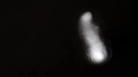 Vortex ring moving towards right in a black background, slow motion Stock Footage 115805447