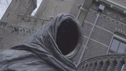Vortex shoot of a faceless statue with an old tower castle in background Stock Footage