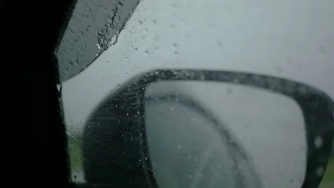 Vortices from the rain on the side window of the car. SLOW MOTION. HD, 1920x1080 Stock Footage 77747105