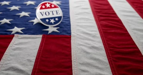 Vote button pin, in the red white and blue of the United States America on .. Stock Footage 282469791