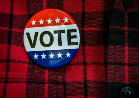 Vote button on red checked shirt Stock Photos