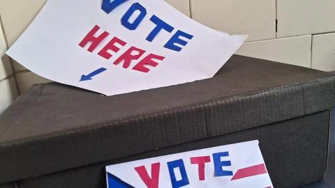 Vote here sign attached to a simple homemade black ballot box 写真素材
