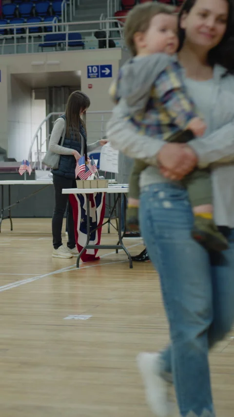 Vote here sign on the floor in polling station Stock Footage 273858725