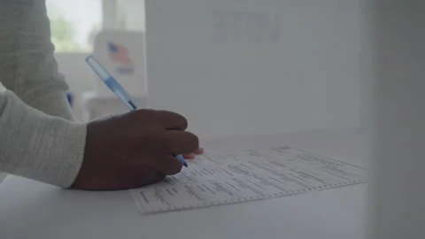 Voter Casting His Vote in a Privacy Box at a Polling Station Stock Footage 219580682