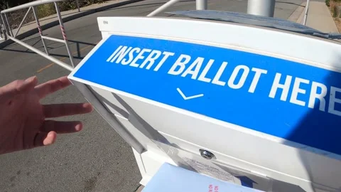 Voter inserting an official U.S. ballot into a drop off box in California. Stock Footage 142583262
