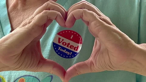 Voter making a hand heart shape over her I voted today sticker Stock Footage 201965664