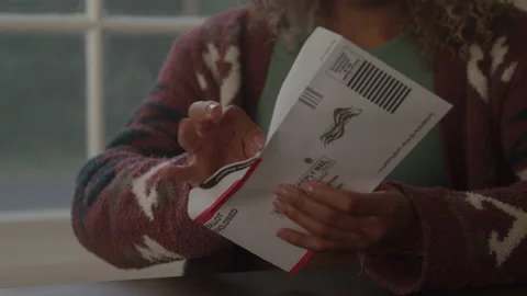 Voter Puts Ballot In Envelope Stock Footage 219599368