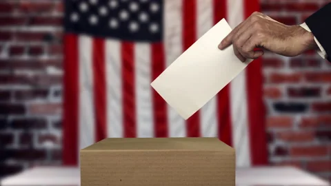 Voter putting envelope with vote on voting ballot, American flag on the back Stock-Footage 140400132