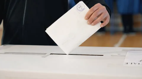 Voters casting ballots inside polling station on election day Stock Footage 320962192