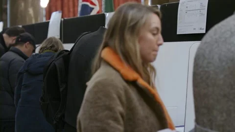 Voters complete their ballot papers at voting booths Stock-Footage 345299028