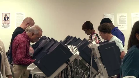 Voters at electronic terminals cast ballots early for 2016 presidential election Stock Footage