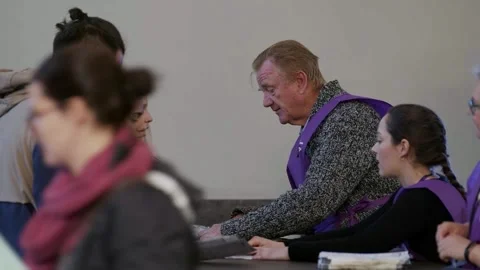 Voters at the issuing desk inside the overseas polling place Stock-Footage 345298967