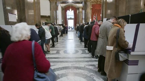 Voters queue along a marble corridor inside Australia House Video stock 345299011