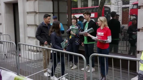 Voters queue behind barriers outside Australia House in London Video stock 345298830