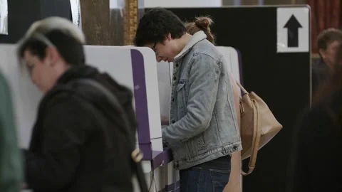 Voters queue at the voting booths inside Australia House Video stock 345299039