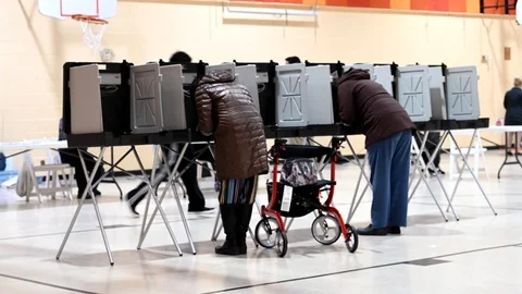 Voters stand casting primary ballots in Michigan. Stock-Footage 126129278