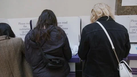 Voters at voting booths inside Australia House Stock-Footage 345299049